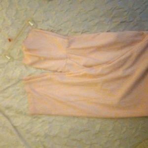 Powdered pink jumpsuit witha sweet heart neck line and poxkets